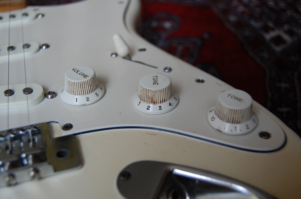 Wiring modded to give the ability to totally  take the middle pickup to ground so the customer could use the switch to switch the pickups on off during feedback. The middle tone is a volume cut for the centre pickup in full on it works just like a normal strat.