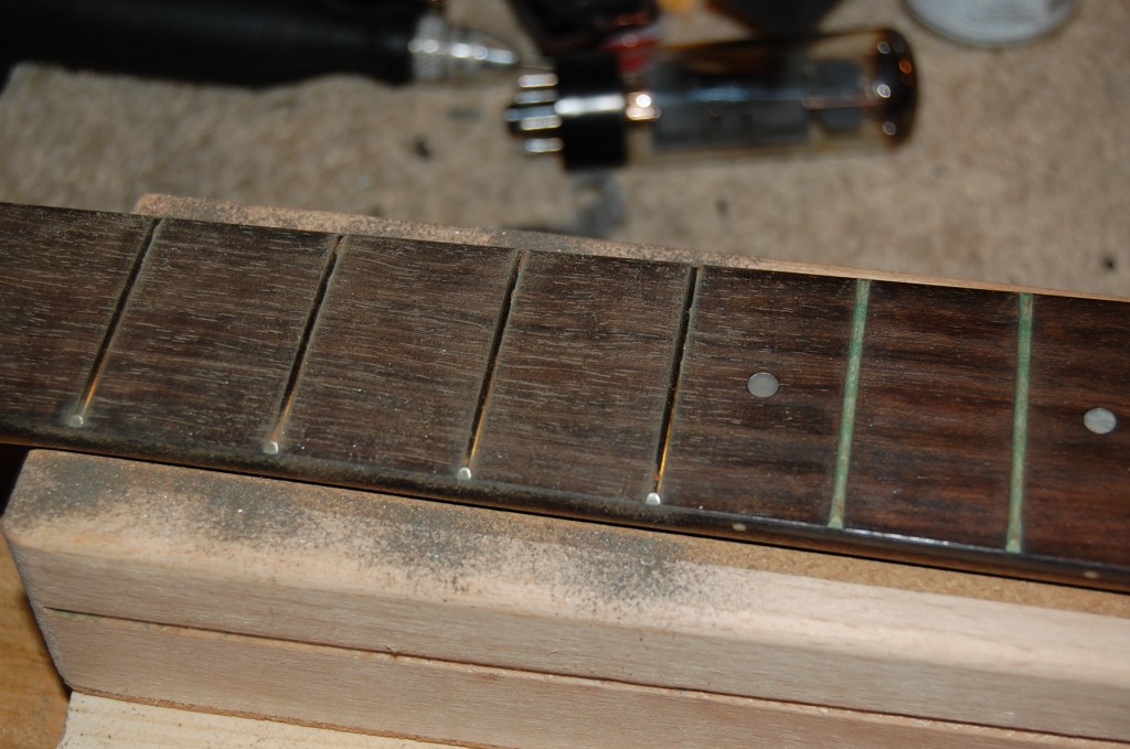 Simple fast clean up using wire wool, this would not be the first approach if this guitar was of significant value ;-)